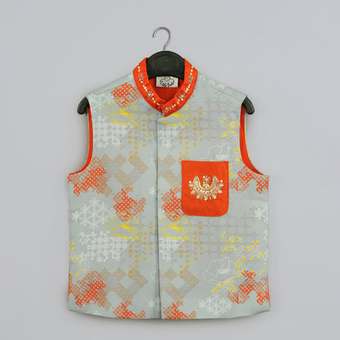 Pre-Order: Orange Kurta With Grey Geometrical Printed Bundi Jacket With Hand Embroidery And Pajama Set