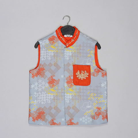 Pre-Order: Orange Kurta With Grey Geometrical Printed Bundi Jacket With Hand Embroidery And Pajama Set
