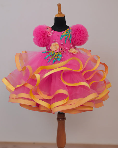 Pre-Order: Flamingo Pink Twirled Gown Embellished with Artificial Flowers  and Greenish Blue Petals