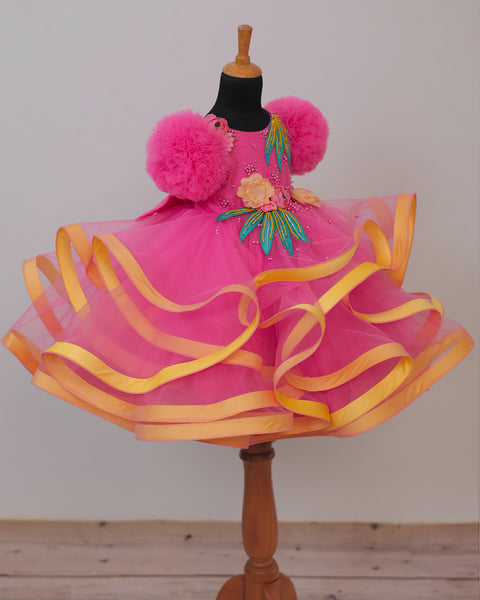 Pre-Order: Flamingo Pink Twirled Gown Embellished with Artificial Flowers  and Greenish Blue Petals
