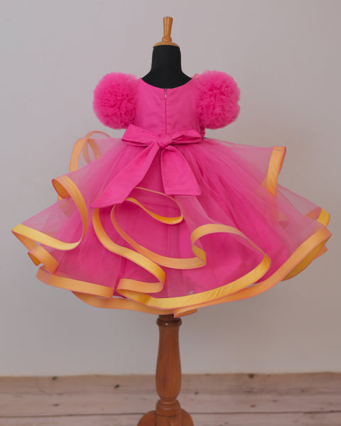 Pre-Order: Flamingo Pink Twirled Gown Embellished with Artificial Flowers  and Greenish Blue Petals