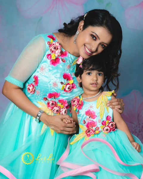 Pre-Order: Pale Aqua Blue Twirled Long Gown with Pink and Yellow Hand-Crafted Flower and Detailing