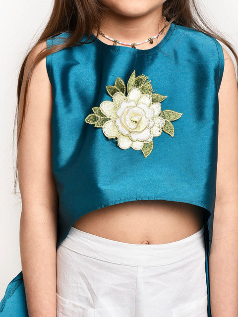 Turquoise Asymmetric Flower Emblished top and White shorts