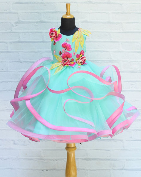 Pre-Order: Pale Aqua Blue Twirled Gown With Pink And Yellow Hand-Crafted Flower And Detailing