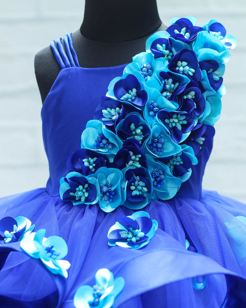 Pre-Order: Royal Blue Swirled One Shoulder Gown With Royal Blue & Sky Blue Flower Work